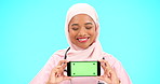 Phone, green screen and woman doctor isolated on blue background healthcare, tracking marker and mockup space. Face of nurse or muslim person with medical mobile app for advertising video in studio