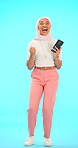 Phone, face and Muslim woman, winner and celebration in studio isolated on blue background mockup. Success, portrait or excited Islamic person with cellphone for winning lottery, prize or competition