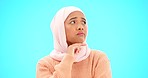 Muslim woman, thinking and idea in studio with hand on chin for mockup, advertising or choice. Islamic female with hijab and face emoji to think, doubt or confused on a studio blue background 