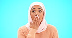 Muslim woman, omg and surprise with hand on mouth for mockup, advertising or promotion. Islam female with hijab and face emoji for reaction to sale, gossip or secret on a studio blue background