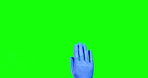 Healthcare, gloves or hand gesture with a doctor on a green screen background in studio for interactive communication. Health, love and heart with a medicine professional indoor for medical insurance