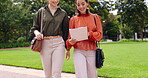 Walking, paperwork and business women in a park holding a document in discussion in the morning commuting to work. Relax, people and friends or colleagues walk and talk together outdoors