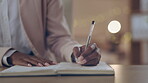 Closeup, hands and notebook writing in night office for business deadline management, task goals and overtime schedule. Woman, pen and working late employee with planner book for company startup idea