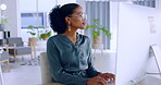 Business woman, computer and typing for communication, email or doing administration at office. African American female employee working on desktop PC in admin, finance or corporate data at work desk
