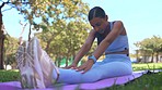 Yoga, stretching and woman doing a exercise in nature for body, spirit and mental wellness. Fitness, health and healthy Indian female doing a warm up meditation workout in a green garden or park.