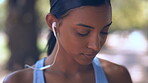 Music, earphones and woman outdoor for fitness, exercise and training in nature. Radio, sports and Indian athlete listening or streaming audio, sound or podcast while workout, running or cardio.
