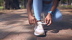 Hands, tie shoes and fitness outdoor to start running, exercise or training at park. Sports, athlete and woman tying sneakers to get ready for cardio, workout or exercising for health and wellness. 