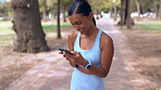 Phone, laughing athlete and woman at park on break with comedy, meme or joke after run. Sports, cellphone and funny Indian person browsing online, social media or comic video after training outdoor