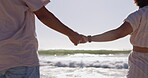 Walking, love and holding hands with couple at beach for travel, relax and summer vacation. Happy, relationship and romance with man and woman on date for bonding, affectionate and commitment