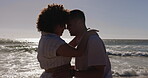 Beach, forehead and couple on a date at the sea or ocean together on holiday or summer vacation. Romantic, man and woman embrace for love, care and support or people in a relationship for happiness