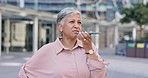 Phone call, speaker and senior woman in town, speaking and connection for conversation, voice note or planning. Mature female, person or lady in city, listening or loudspeaker in street or smartphone