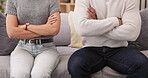 Fight, angry and hands of couple on sofa for breakup, frustrated and conflict. Divorce, sad and communication with man and woman in living room at home for problem, depression and mental health