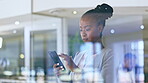 Phone, business and black woman texting in office, social media or browsing online by window. Cellphone, professional and serious female person on web, internet scrolling or networking in workplace.