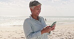 Phone, relax and senior woman at beach for text message, social media and communication. Contact, summer and travel with female reading online in outdoors for networking, technology and internet