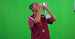 Dancing, black woman and trophy kiss on green screen in studio isolated on a background mockup. Celebration medal, winner and face portrait of person happy to celebrate winning, success and award.