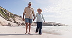 Walking, beach and senior couple holding hands and happy on summer vacation or holiday. Old man and woman talking about love, care and fun sea walk or freedom outdoor on travel in retirement together