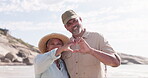 Happy, heart and hands with old couple on beach for love, romance and affectionate. Travel, smile and happiness with portrait of man and woman for support, trust and summer vacation trip