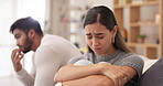 Couple, sad woman and divorce after disagreement or argument on sofa in living room dispute or unhappy relationship at home. Emotional woman and man crying in breakup, cheating or affair from fight