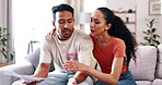 Couple, debt and documents or finance problem on home couch arguing about bills or mortgage. Young man and woman together in a house with paperwork, stress and  crisis while talking about budget