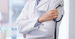 Closeup of person, doctor and arms crossed with stethoscope in hospital, clinic or life insurance. Hands of medical worker, cardiology expert and ready for healthcare services, consulting or medicine