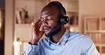 Black man, call center and headache at night in stress, burnout or overworked from customer service at office. Tired African American male consultant or agent working late suffering from bad migraine