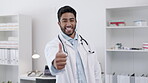 Indian doctor, face or happy man with a thumbs up for healthcare, medical consulting or success. Smile, thank you or portrait of a surgeon showing a good hand gesture for hospital work or insurance