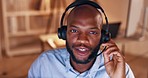 Black man, telemarketing and consultant talk at night at a crm office with customer support. Call center, working and conversation of a business employee and consultation talking about tech help