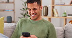 Laughing, phone and relax with man on sofa for social media, internet and text message. Happy, smile and technology with male in living room at home for communication, connection and digital app