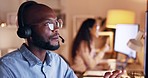 Black man, telemarketing and communication at night at a crm office with customer support talk. Call center, working and conversation of a business employee and consultation talking about tech help