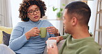 Couple drinking coffee, have conversation and relax on living room couch, communication and spending quality time together. Partner, love and respect with hot beverage, people talking and connection