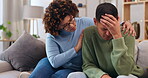 Couple, support and woman with sad man, empathy and comfort w love while sitting in living room at home. Grief, loss and mental health with depression, stress and people in relationship in crisis