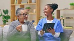 Nurse, caretaker and elderly man with tablet and communication for teaching about tech. Retirement home, healthcare worker and nursing employee talking to senior male about an online app on a sofa