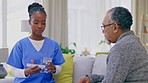 Senior man, nurse and explain with pills in house for retirement, wellness and health advice talk. Nursing home, black woman and elderly male with medicine, consulting and chat for healthcare service