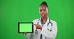 Doctor pointing, green screen or black woman with tablet in marketing, advertising or product placement. Explaining, talking or girl portrait on mockup space for healthcare clinic logo or information