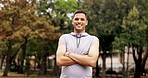 Happy, fitness and face of proud man in park for sports, workout or morning run or jog. Smile, portrait and indian guy in forest for training, workout or cardio, positive mindset and arms crossed