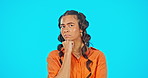 Thinking, confused and face of a woman with a decision isolated on a blue background in studio. Contemplation, idea and a portrait of a girl looking thoughtful and with doubt on backdrop with mockup