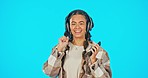 Woman, face and headphones with smartphone, dance with smile and listen to music on blue background. Mockup, fun and freedom with energy, female in portrait with radio app and technology in studio