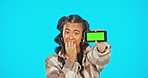 Phone, green screen and nervous woman in studio advertising website, mobile app or network connection. Portrait of gen z female model with smartphone and anxiety or biting nails for social media post