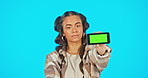 Phone, green screen and serious woman in studio advertising website, mobile app or network connection. Portrait of gen z female model with smartphone in hand for product placement or disappointment
