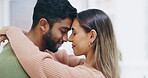 Love, romance and a couple hugging in the living room of their home together for affection while dating. Hug, relax or eyes closed with a man and woman bonding in their apartment for intimacy