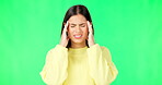 Green screen, headache and woman isolated on studio background with migraine, stress or pain. Frustrated, angry and burnout, temple massage and young person with sick or health risk in mockup space