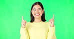 Happy, woman and face on green screen pointing up to mockup background, studio and smile. Portrait of female model advertising promotion, product placement and hands showing announcement coming soon