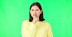 Secret, green screen and face of serious woman in studio, finger and lips on background for privacy. Portrait, angry female model and silence of noise, shush on mouth and quiet for confidential emoji
