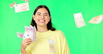 Happy woman, cash and money rain on green screen for winning, prize or lottery against a studio background. Portrait of female winner with smile for financial freedom, wealth or investment on mockup