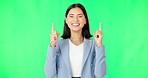 Green screen, business and face of happy woman pointing up to news on mockup color background. Portrait of female employee advertising promotion, product placement or presentation of deal coming soon