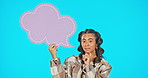 Speech bubble, thinking and mockup with woman in studio for feedback, social media and idea. Review, promotion and icon with portrait of female on blue background for opinion, communication and sign