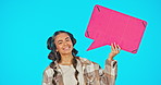 Speech bubble, advertising and social media with woman, face and smile with mockup on blue background. Voice, opinion and product place with branding and happy young female in portrait in studio