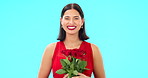 Rose flowers, face and happy woman in studio, blue background and color backdrop. Portrait of female model, plant bouquet and floral gift for celebration of love, romantic present and valentines day