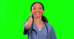 Face, nurse and woman with thumbs up on green screen in studio isolated on a background mockup. Portrait, hand gesture and happy medical surgeon with like emoji for success, agreement or healthcare.