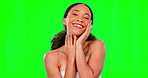 Portrait, skincare and happy with a woman on a green screen background in studio for wellness. Luxury, relax and beauty with an attractive young female rubbing or touching her soft and smooth skin